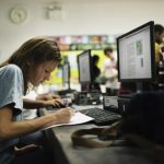 caucasian-woman-writing-at-computer-room-P3LMJ84-639×420